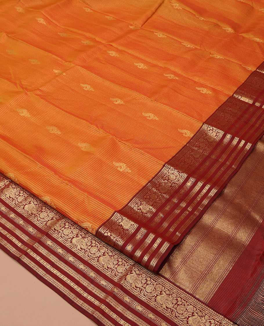 Orange Vasundhara Silk Saree, Masterfully Woven with Zari Buttas and Checks All Over Its Body, Complemented by a Contrast Border of Thilakam Mokku, Manga, Mayil, and Meen Designs, Grand Pallu, and Paired with a Contrast Blouse