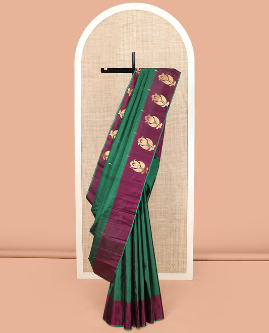 Green Kanchipuram Silk Saree Beautifully Sparkled with Zari Buttas, Complemented by a Contrast Border of Floral Zari Designs, Pallu Adorned with Floral Designs, and Paired with a Contrast Blouse