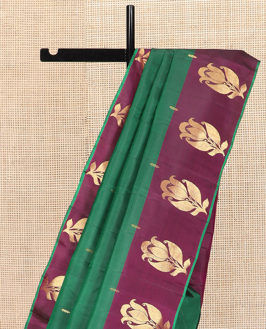 Green Kanchipuram Silk Saree Beautifully Sparkled with Zari Buttas, Complemented by a Contrast Border of Floral Zari Designs, Pallu Adorned with Floral Designs, and Paired with a Contrast Blouse
