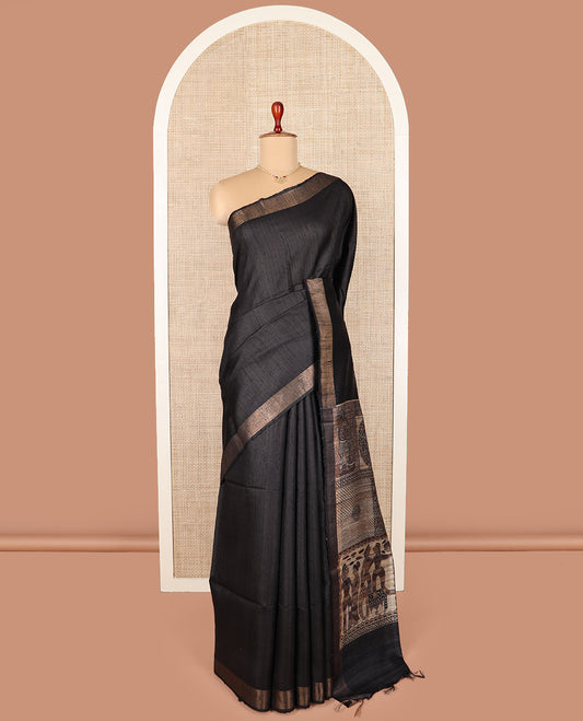 Grey tussar silk saree, bavanji border, and pallu features Madhubani human motifs print