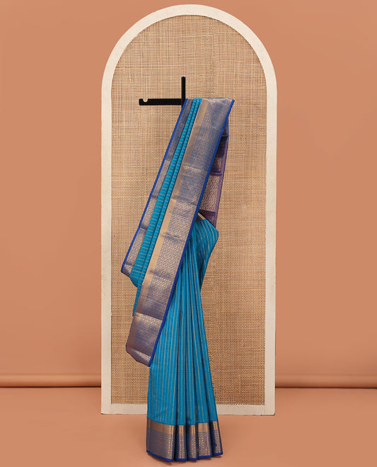 Blue Vasundhara Lite Silk Mix Saree Highlighted with Zig-Zag Stripes, Complemented with a Contrast Border Featuring Rekku, Annam, Chakram, and Manga Designs, Pallu Adorned with the Same Border Motifs, and Paired with a Contrast Blouse