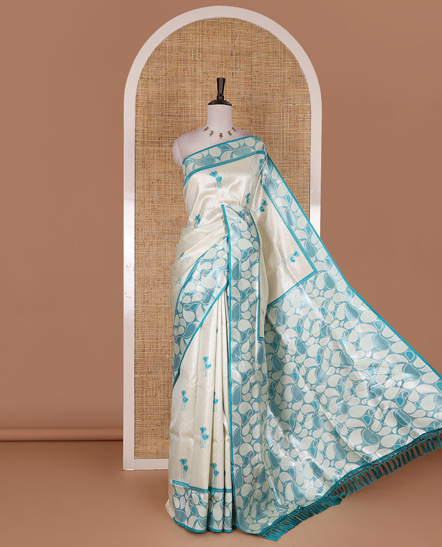 Half-white jacquard kanchi silk saree, contrast border, and pallu steeped with paisley motifs with contrast zari design blouse