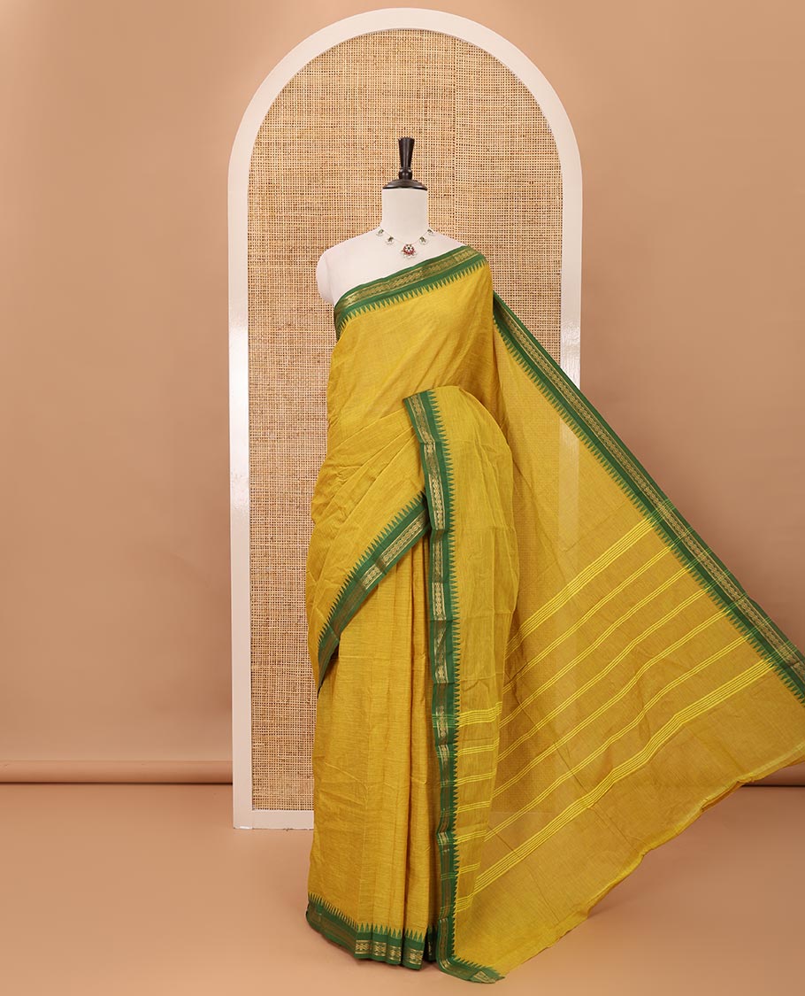 Mustard color plain design chettinadu cotton saree, contrast temple traditional design border, striped pallu & batik-printed blouse