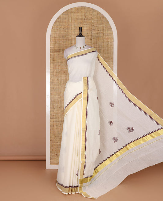 Half-white and maroon leaf motifs printed Kerala cotton saree, temple gold zari border, gold zari pallu, and matching blouse