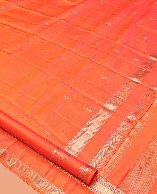 Orange Kanchipuram Silk Saree, Ornamented with Manga Buttas, Highlighted By Zari Rettai Pettu Border of Manga, Banaras, Mayil Kann, and Arai Maadam Design, Grand Pallu, and a Matching Blouse