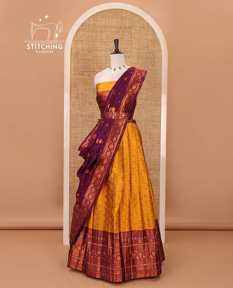 Mustard semi-banaras half-saree, embossed & contrast traditional zari border skirt,blouse of embossed & zari work & contrast-magenta zari design dhavani
