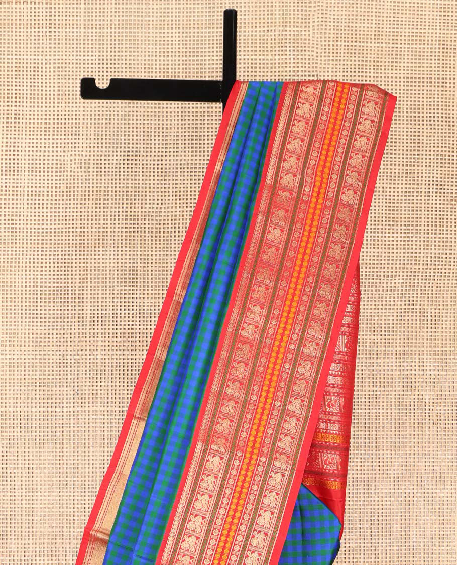 Blue and Green Kanchipuram Silk Saree, Decked Up with Checked Design on Its Body, Complemented by a Contrast Border of Thilakam Mokku, Mayil, Laddu Kamalam, and Rudraksham Designs, Pallu Steeped with Traditional Designs, and Paired with a Contrast Blouse