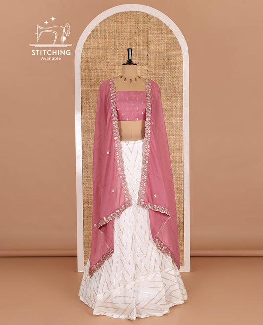 Cream-pink half-saree, gold chevron striped nylon viscose crepe skirt, contrast diamond buttas blouse, and  a contrast scallop floral-theme embroidered dhavani
