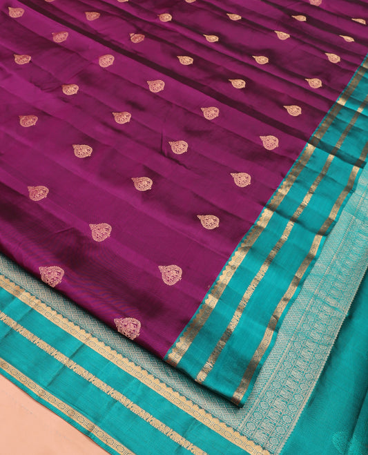 Purple Budget Silk Saree, Spotlighted with Zari Buttas On Its Body, Complemented by Contrast Border of Rekku, Laddu Kamalam, Mayil, and Yaanai Designs, Grand Jaal Pallu, and Paired with a Contrast Blouse
