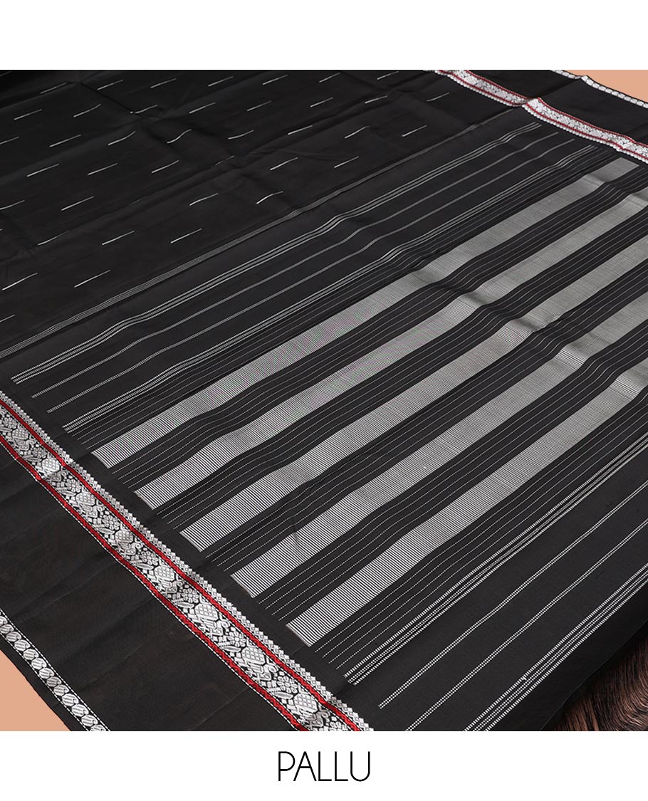 Black Kanchipuram Silk Saree, Delicately Woven with Buttas All Over Its Body, Highlighted by a Rettai Pettu Border of Thilakam Mokku, Neli, Mayil, and Manga Designs, Pallu Steeped with Stripes, and Paired with a Matching Blouse