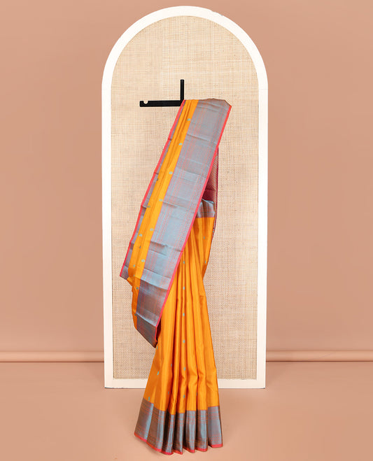 Yellow Kanchipuram Silk Saree, Decked Up with Mayil-Chakram Buttas on Its Body, Complemented by a Contrast Border of Rekku, Banaras, Rudraksham, Neli, and Vanki Designs, Pallu Steeped with Kamalam Designs, and Paired with a Contrast Blouse