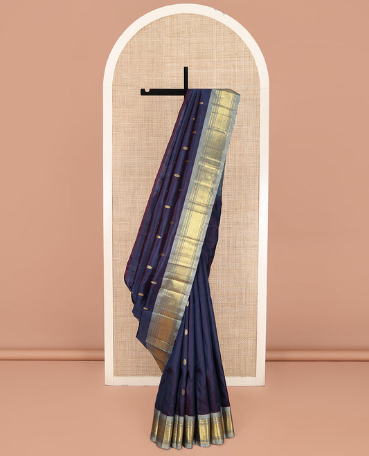 Navy Blue Kanchipuram Silk Saree, Beautified with Zari Buttas on Its Body, Complemented by a Contrast One-Sided Border of Paneer Sombu, Banaras, Muthu and Jaal Designs, Pallu of Zari Designs, and Comes Without a Blouse