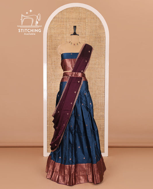 Blue taffeta silk half-saree, zari buttas with contrast traditional zari bordered skirt, matching zari design blouse, and contrast scallop buttas embroidered dhavani