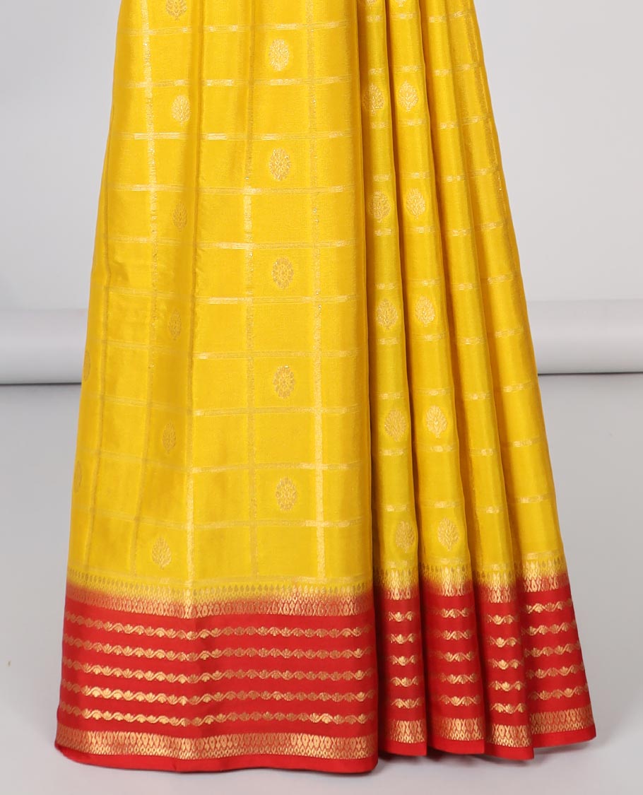 Yellow floral motifs enclosed with checked mysore silk saree with contrast striped zari border & pallu of intricate design