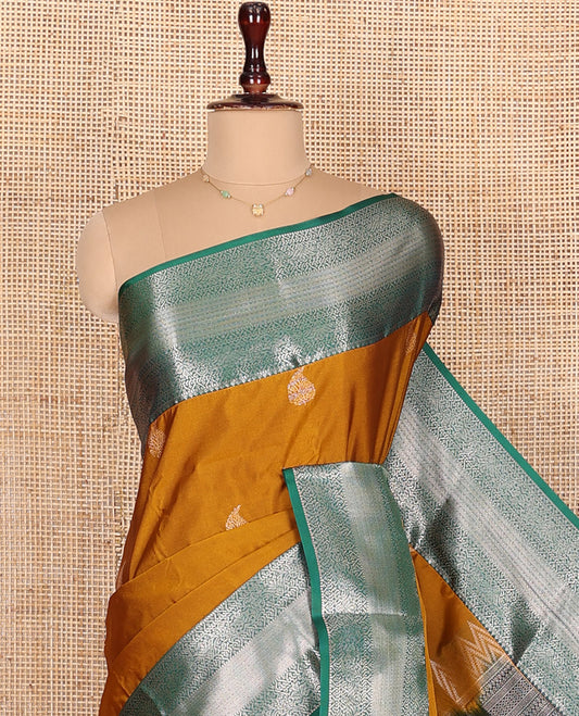 Mustard Budget Silk Saree, Enriched with Paisley Zari Buttas All Over Its Body, Complemented by a Contrast Traditional Zari Designs Woven Border, Majestically Detailed Pallu, and Paired with a Contrast Blouse