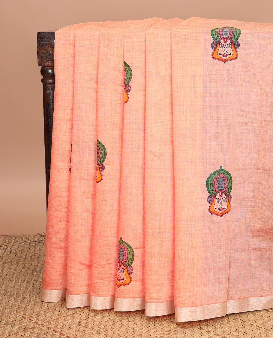 Peach kathakali buttas printed chirala cotton saree, bavanji border, and contrast musical motifs print pallu
