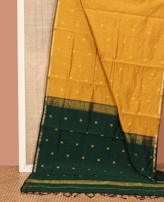 Mustard Maheshwari Cotton Saree, Delicately Woven with Flower Buttas All Over Its Body, Subtly Woven Piping Border, Captivating Contrast Pallu Steeped with Buttas, and Paired with a Contrast Blouse