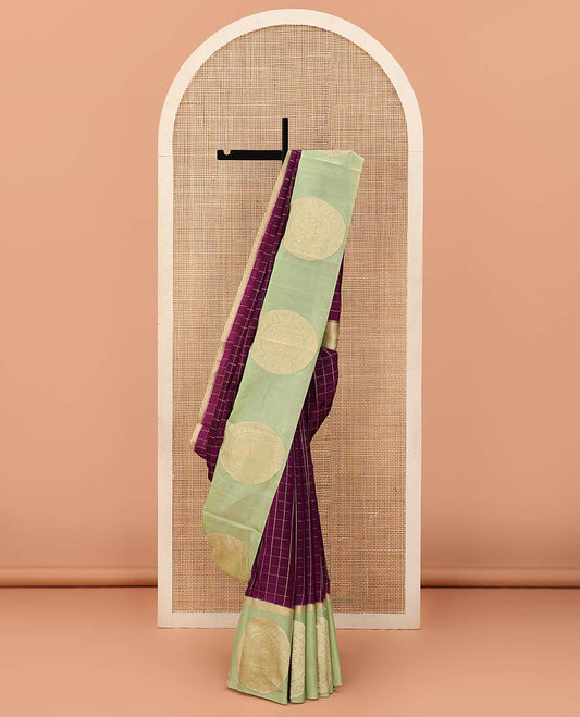 Purple Raw Mango Silk Saree Enthralled with Checks, Features a Contrast Chakram Motifs Border, a Zari-Elevated Pallu, and Paired with a Contrast Blouse