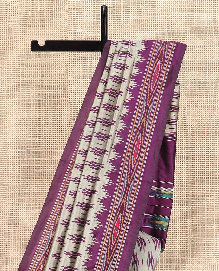 Grey Ikkat Silk Saree Highlighted with Ikkat Buttas, Featuring a Contrast Ikkat Temple Border in Ikkat Weave, and a Pallu Showcasing Ikkat Texture and Stripes