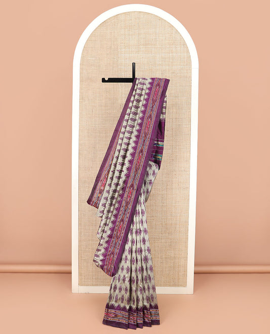 Grey Ikkat Silk Saree Highlighted with Ikkat Buttas, Featuring a Contrast Ikkat Temple Border in Ikkat Weave, and a Pallu Showcasing Ikkat Texture and Stripes