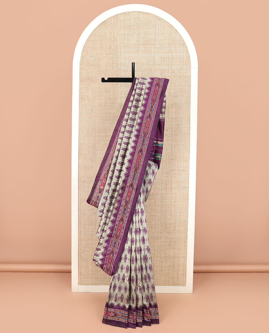 Grey Ikkat Silk Saree Highlighted with Ikkat Buttas, Featuring a Contrast Ikkat Temple Border in Ikkat Weave, and a Pallu Showcasing Ikkat Texture and Stripes