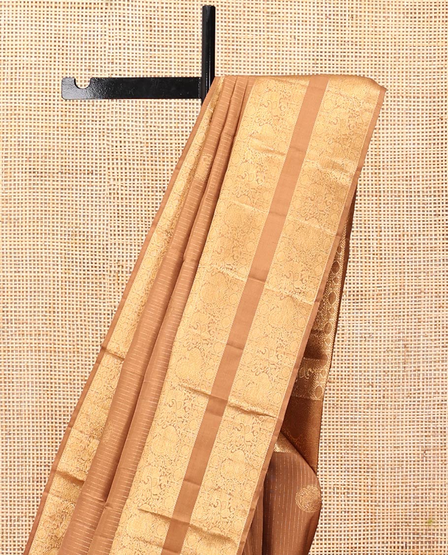 Pale Brown Kanchipuram Silk Saree, Subtly Sparkled with Zari Designs, Highlighted by a Zari Rettai Pettu Border of Poun, Mayil, and Kuthirai Designs, Grand Pallu, and Matching Blouse