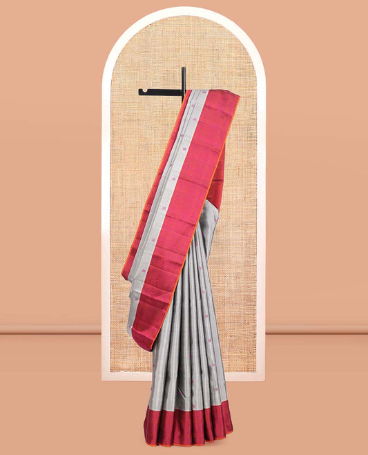 Grey Kanchipuram Silk Saree, Subtly Sparkled with Mayil-Chakram Buttas, a Contrast Border of Thilakam Mokku, Iruthalai Pakshi, and Kuyil Kann, Jaal Pallu, and a Contrast Blouse