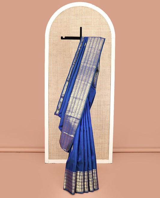 Blue Kanchipuram Silk Saree, Decorated with Zari Buttas All Over Its Body, Highlighted by a Zari Border of Salngai, Muthu, Mayil, and Kuthirai Designs, Grand Jaal Pallu, and Paired with a Matching Blouse