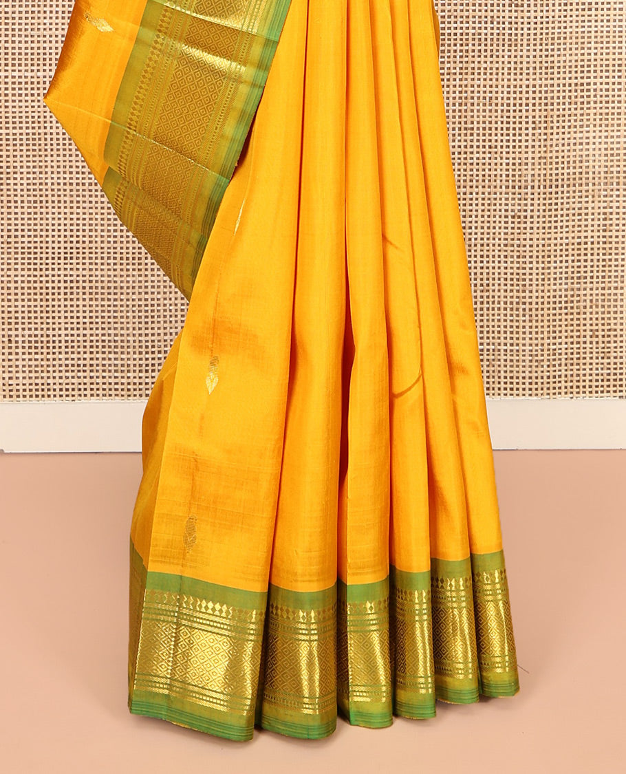 Yellow Kanchipuram Silk Saree Features Buttas, a Contrast One-Sided Border of Panner Sombu, Banaras, Muthu, and Mayil Kann Designs, Zari Design Pallu, and No Blouse