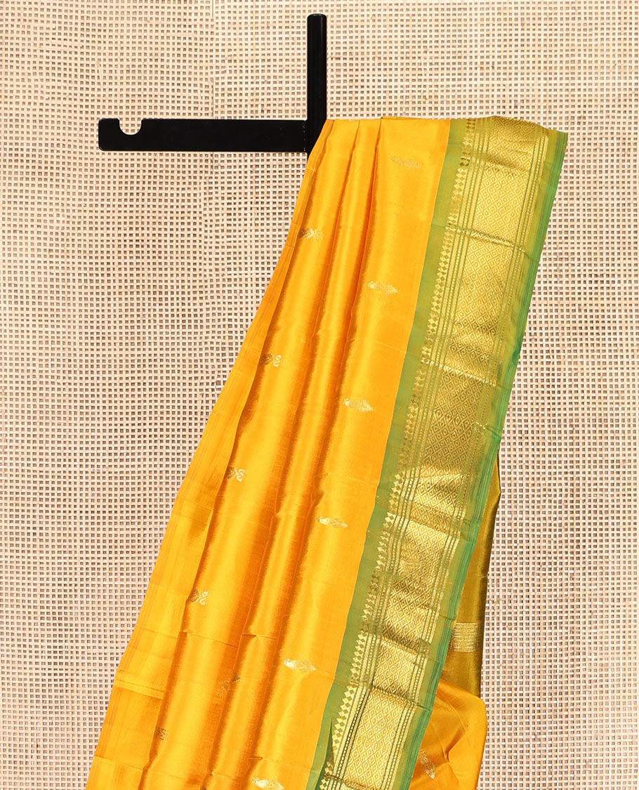 Yellow Kanchipuram Silk Saree Features Buttas, a Contrast One-Sided Border of Panner Sombu, Banaras, Muthu, and Mayil Kann Designs, Zari Design Pallu, and No Blouse