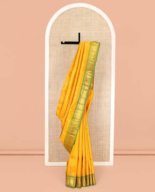 Yellow Kanchipuram Silk Saree Features Buttas, a Contrast One-Sided Border of Panner Sombu, Banaras, Muthu, and Mayil Kann Designs, Zari Design Pallu, and No Blouse