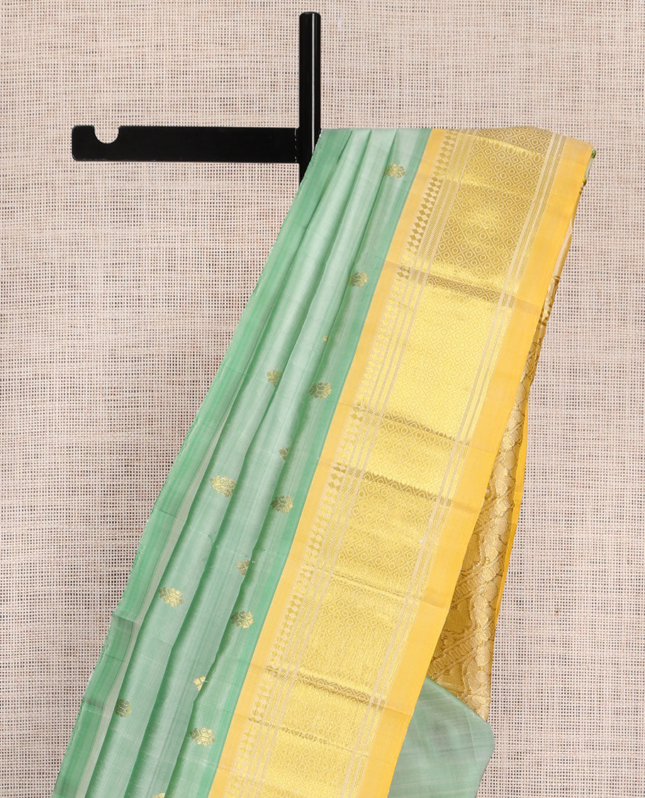 Green Kanchipuram Silk Saree, Woven with Zari Buttas, a Contrast One-Sided Border of Panner Sombu, Banaras, and Jaal Designs, Floral Creeper Pallu, and No Blouse