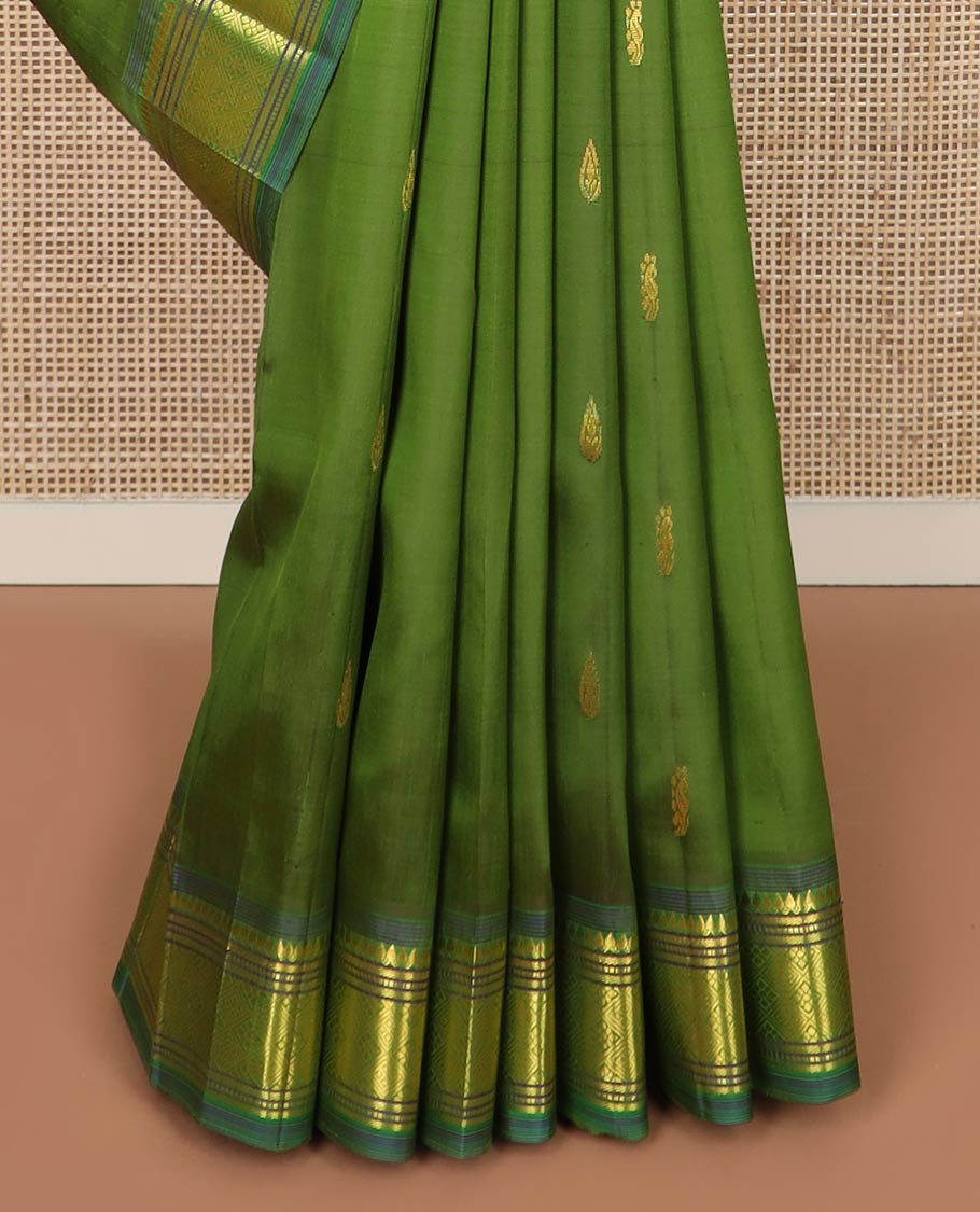 Green zari buttas silk saree, contrast one-sided border of thilakam mokku, banaras, muthu & jaal designs & zari design pallu