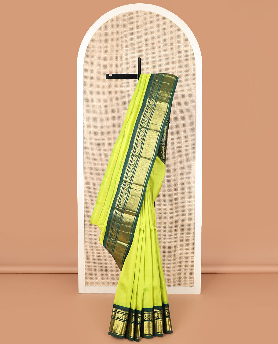 Green zari buttas Kanchipuram silk saree, contrast korvai border of thilakam mokku, kodi visiry, and jaal designs, and pallu of ancient human figurines