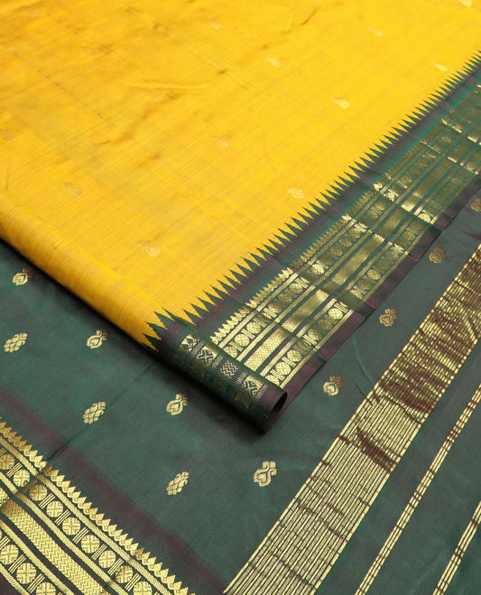 Yellow zari buttas Kanchipuram silk saree, contrast one-sided thazampoo rekku border of thilakam mokku, banaras, rudraksham and vanki designs, and zari design pallu
