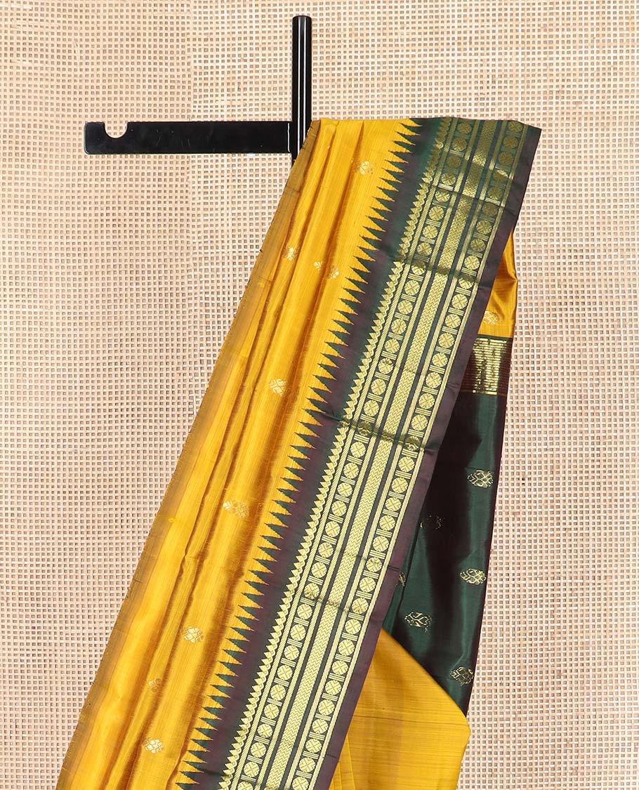 Yellow zari buttas Kanchipuram silk saree, contrast one-sided thazampoo rekku border of thilakam mokku, banaras, rudraksham and vanki designs, and zari design pallu