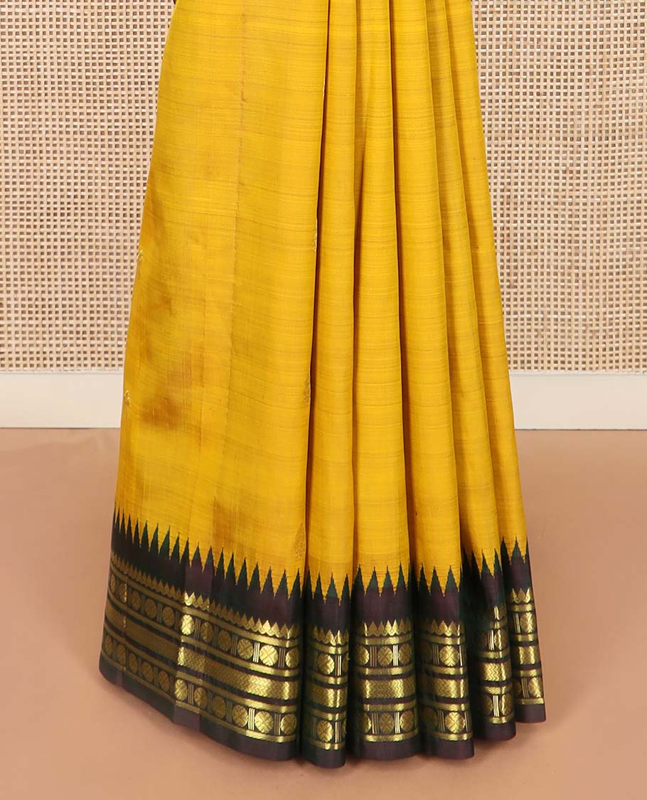 Yellow zari buttas Kanchipuram silk saree, contrast one-sided thazampoo rekku border of thilakam mokku, banaras, rudraksham and vanki designs, and zari design pallu