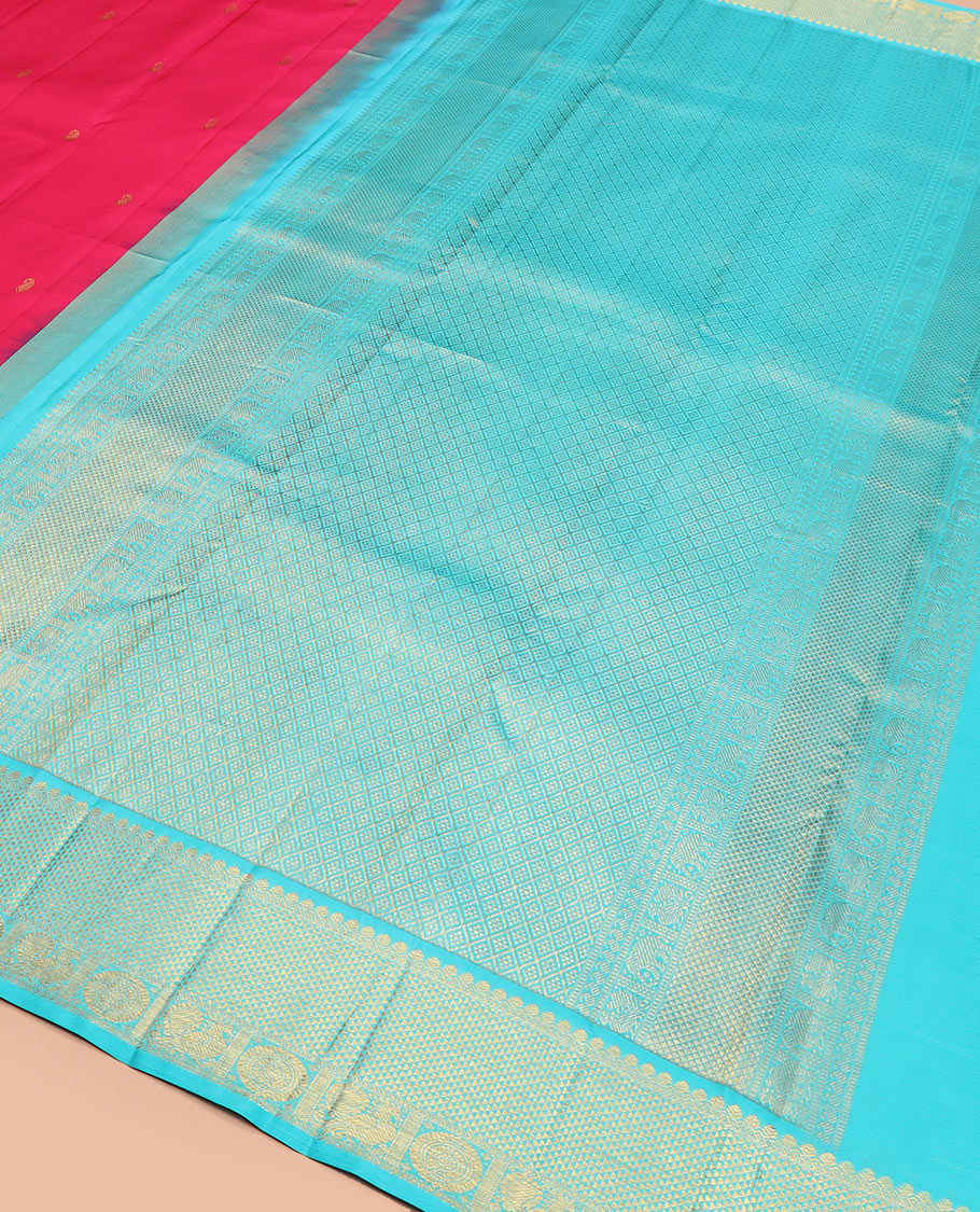 Red vanki manga buttas Kanchipuram silk saree, contrast korvai border of salngai, banaras, ara maadam, and anna chakram designs, and jaal pallu