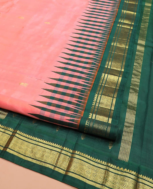 Peach Kanchipuram Silk Saree Adorned with Zari Buttas All Over Its Body, Complemented by a Contrast One-Sided Thazampoo Rekku Border of Thilakam Mokku, and Jaal Designs, Zari Design Pallu, and Comes Without a Blouse