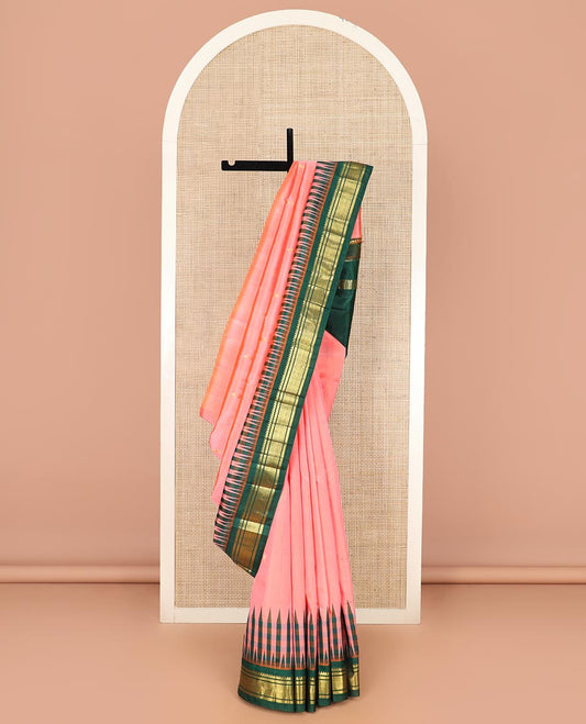 Peach Kanchipuram Silk Saree Adorned with Zari Buttas All Over Its Body, Complemented by a Contrast One-Sided Thazampoo Rekku Border of Thilakam Mokku, and Jaal Designs, Zari Design Pallu, and Comes Without a Blouse