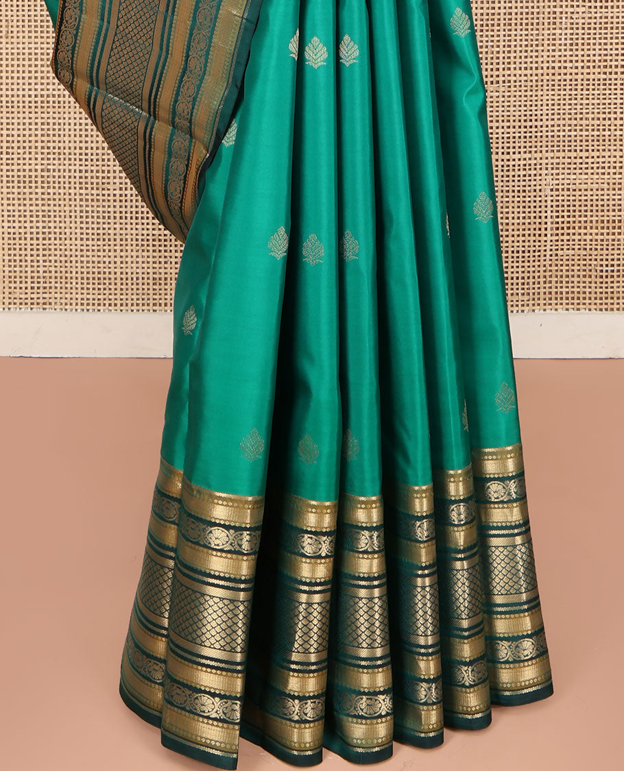 Green Kanchipuram Silk Saree, Detailed with Buttas on Its Body, Complemented by a Contrast Border of Vanki, Kodi Visiry, Neli, Banaras, and Jaal Designs, Grandly Jaal Woven Pallu, and Paired with a Contrast Blouse