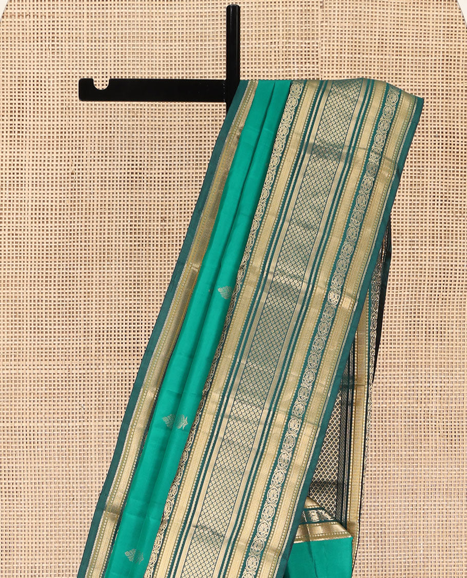 Green Kanchipuram Silk Saree, Detailed with Buttas on Its Body, Complemented by a Contrast Border of Vanki, Kodi Visiry, Neli, Banaras, and Jaal Designs, Grandly Jaal Woven Pallu, and Paired with a Contrast Blouse