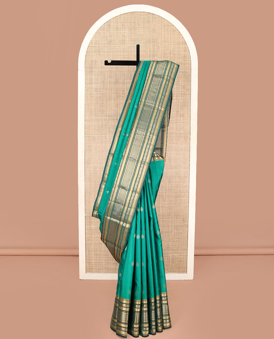 Green Kanchipuram Silk Saree, Detailed with Buttas on Its Body, Complemented by a Contrast Border of Vanki, Kodi Visiry, Neli, Banaras, and Jaal Designs, Grandly Jaal Woven Pallu, and Paired with a Contrast Blouse