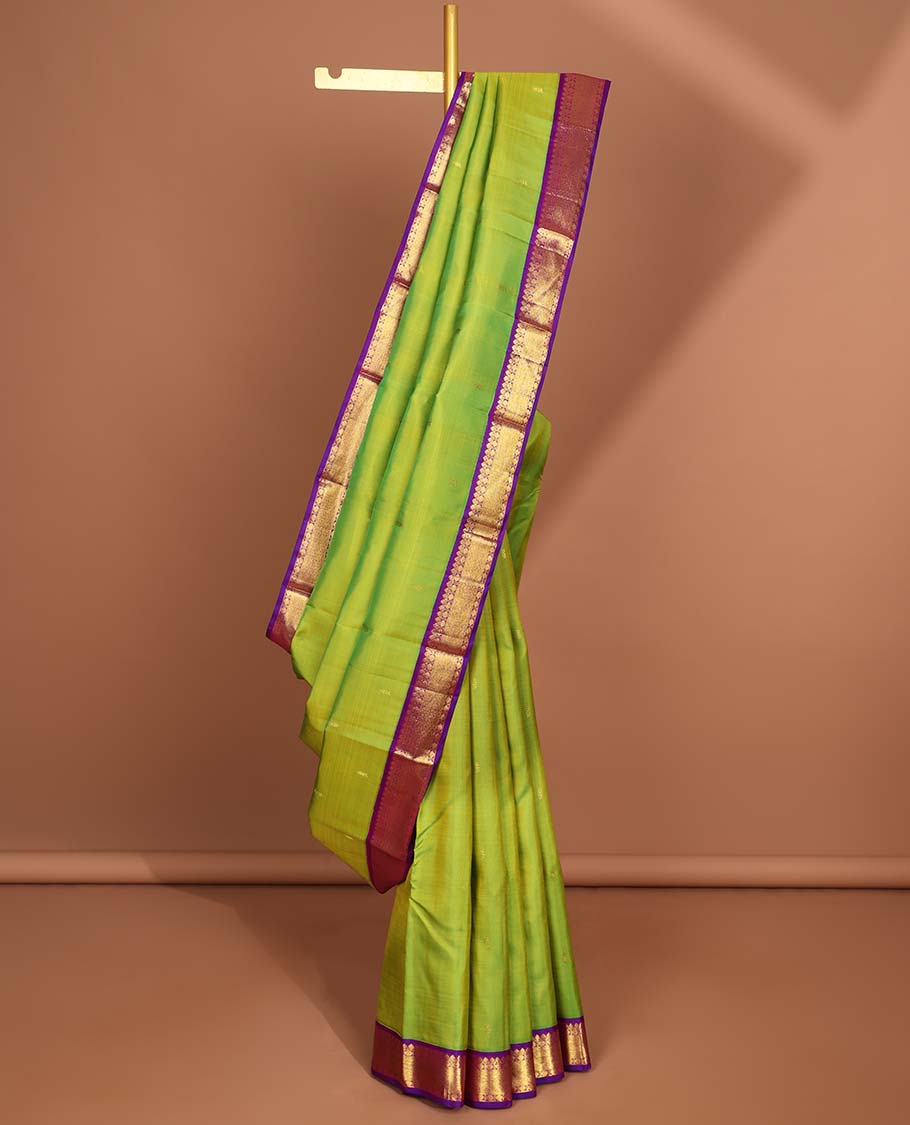 Green leaf buttas kancheepuram silk saree with intricate zari pallu & korvai border of thilakam mokku,paun desigs