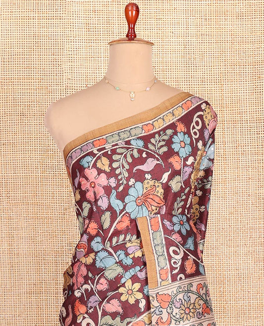 Maroon-Base Semi-Tussar Saree Colorfully Highlighted with Kalamkari-Style Floral Print, Complemented by a Contrast Printed Border, Pallu Depicting Kalamkari Peacock Print, and Paired with a Contrast Blouse