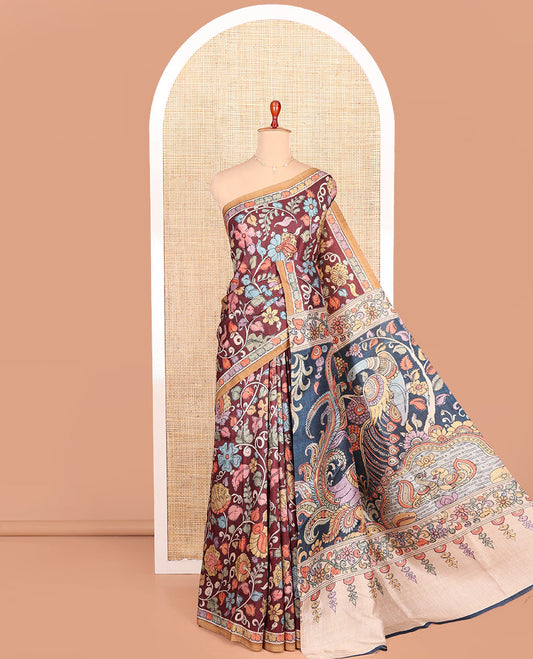 Maroon-Base Semi-Tussar Saree Colorfully Highlighted with Kalamkari-Style Floral Print, Complemented by a Contrast Printed Border, Pallu Depicting Kalamkari Peacock Print, and Paired with a Contrast Blouse