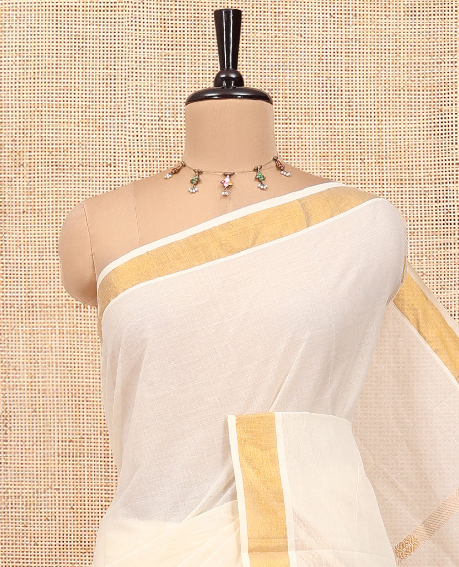 Cream Kerala Cotton Saree, Enthralled with Zari Stripes All Over Its Body, a Subtle Bavanji Border, Pallu of Intricate Designs, and Is Paired with a Matching Blouse