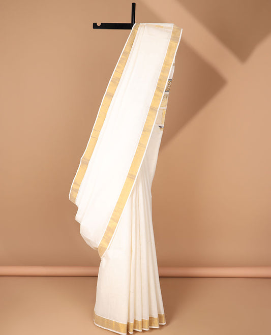 Cream kerala saree with zari designs, zari border & pallu of peacock & butterfly designs