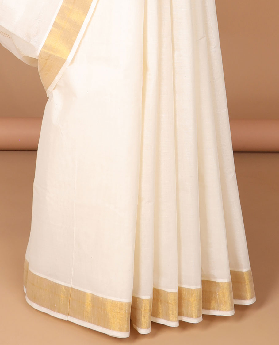 Cream kerala saree with zari designs, zari border & pallu of peacock & butterfly designs