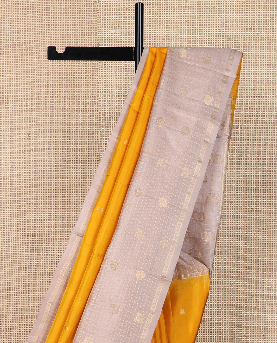 Yellow zari buttas soft silk saree, contrast checked border of annam chakram motifs & zari-rich jaal pallu
